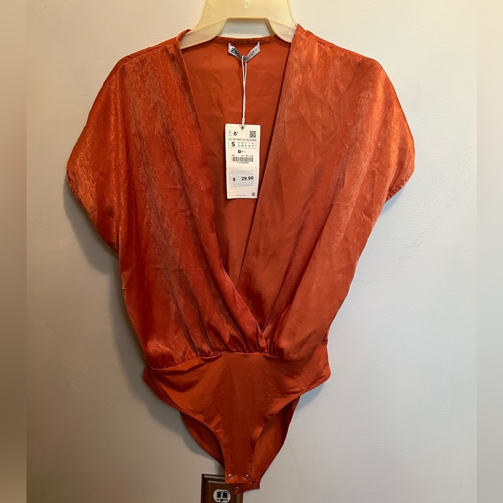 Warm metallic orange with a dramatic V cut